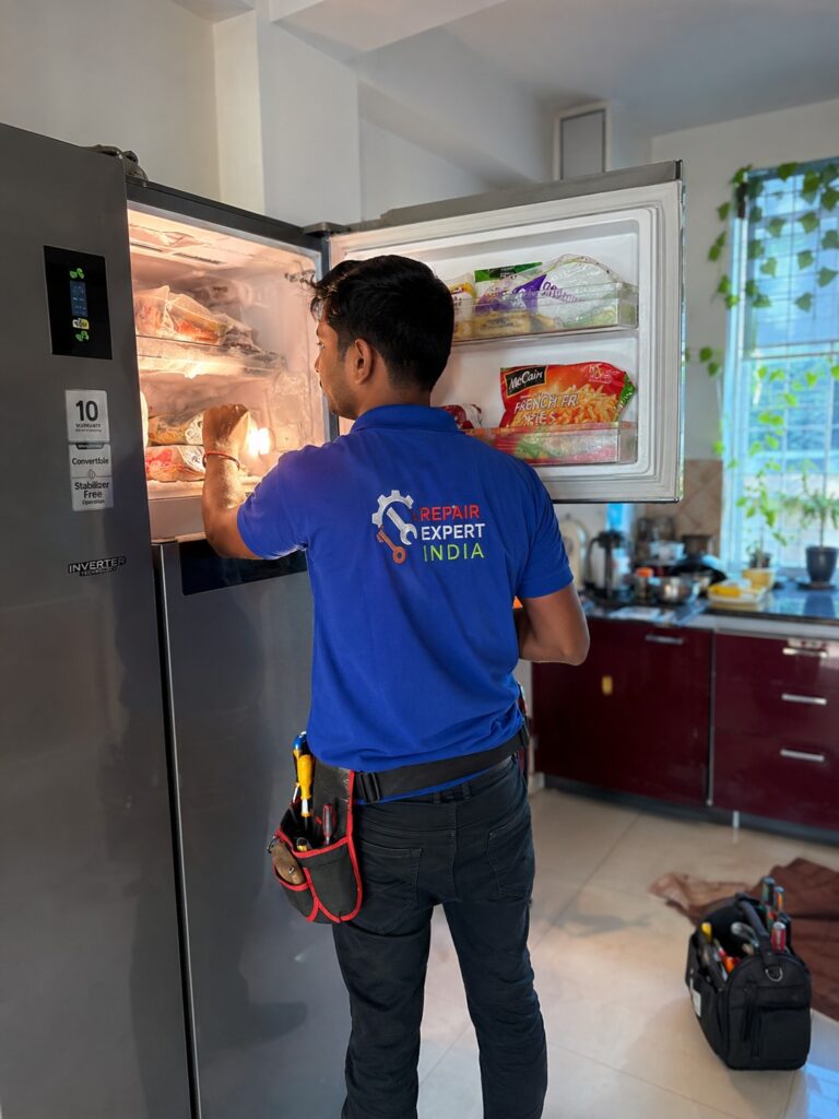 Technician repairing freezer not cooling but light is on problem in Hyderabad home kitchen
