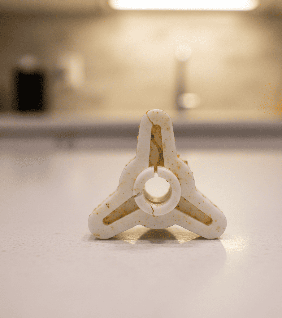 Damaged microwave coupler preventing the turntable from rotating in a Hyderabad kitchen.