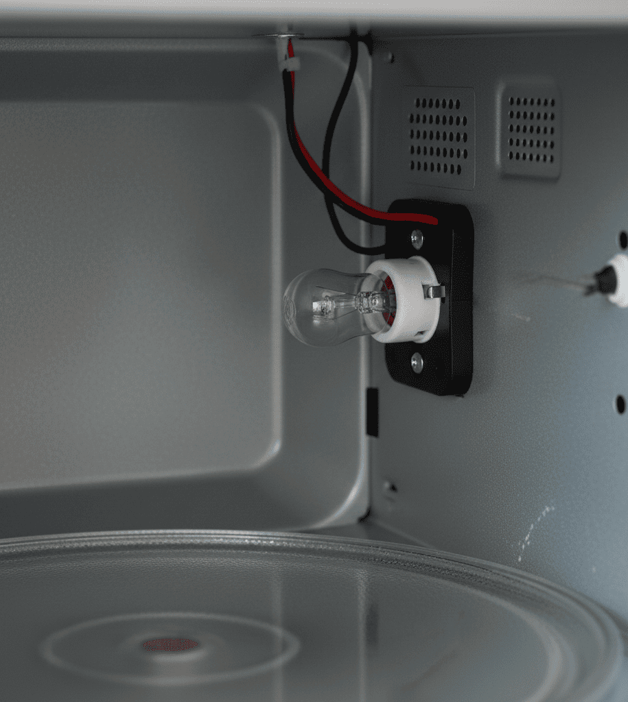 Microwave light socket inspection during repair service in Kolkata