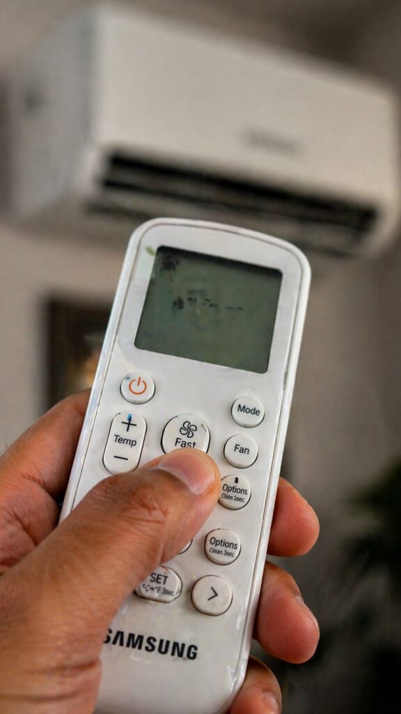 Professional AC technician diagnosing and fixing Samsung AC remote and sensor issues in a Hyderabad apartment for quick and reliable service.